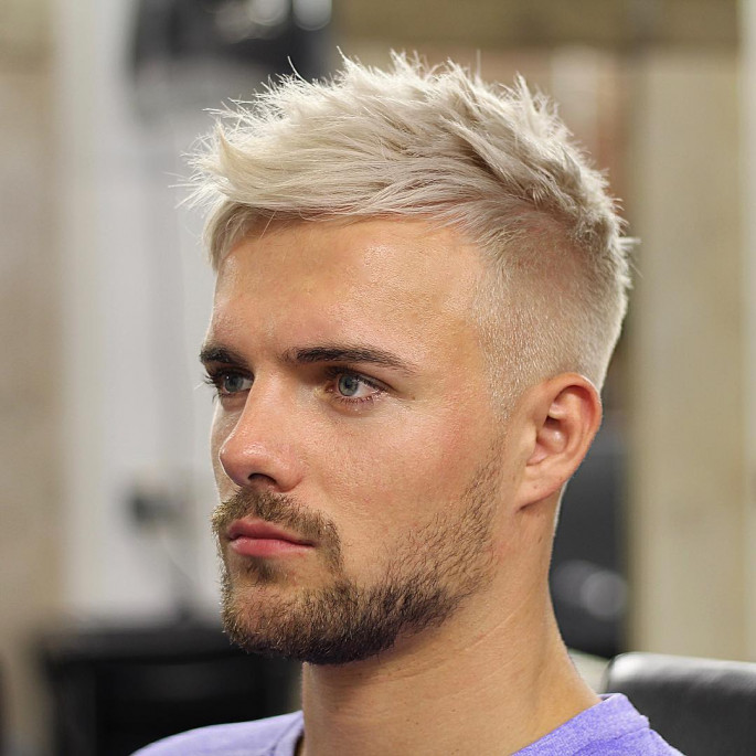 Guy Model With A Stylish Haircut Posing Outdoors In A White Shirt And Gray  Trousers. Trendy Hairstyle Rests Near A Modern Business Center. Attractive  Guy In The Street On A Summer Day.